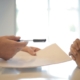 crop businessman giving contract to woman to sign